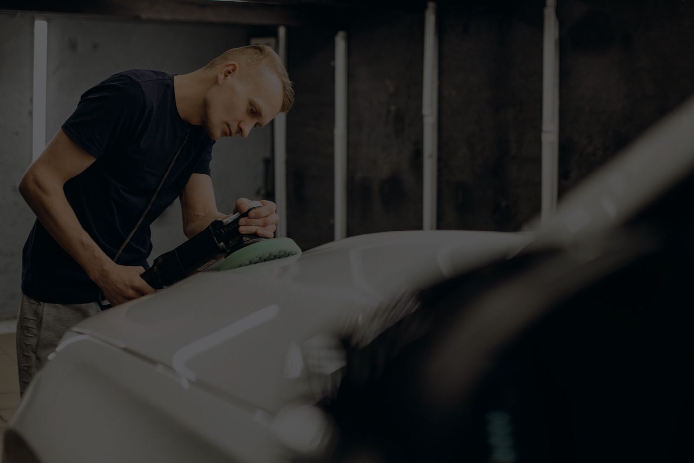 An A1 Performance technician finishing a repaired body panel in the Richmond shop